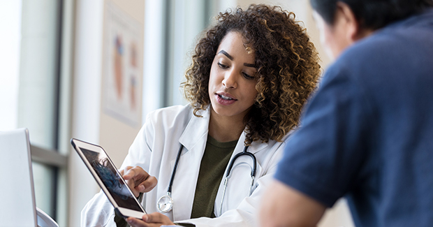 Provider showing patient a tablet with information