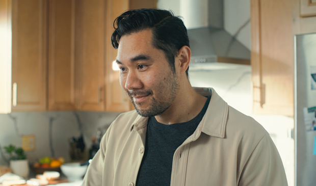 A father smiling in his kitchen