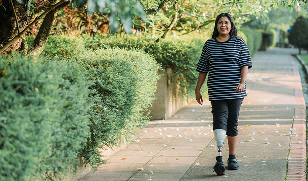 Amputee walking down sidewalk