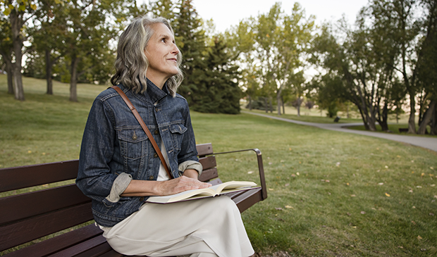 Woman reading on park bench