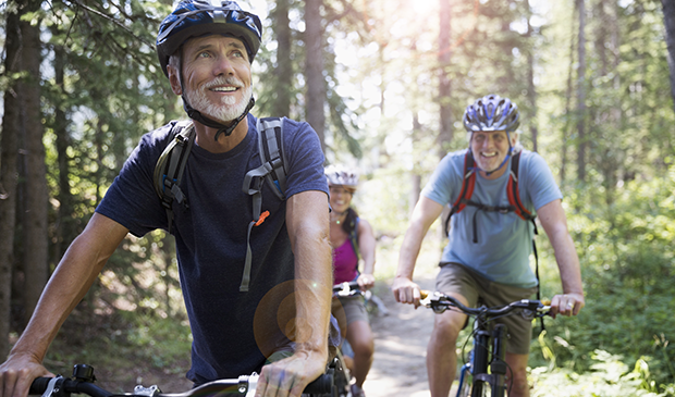Cyclists riding in forest